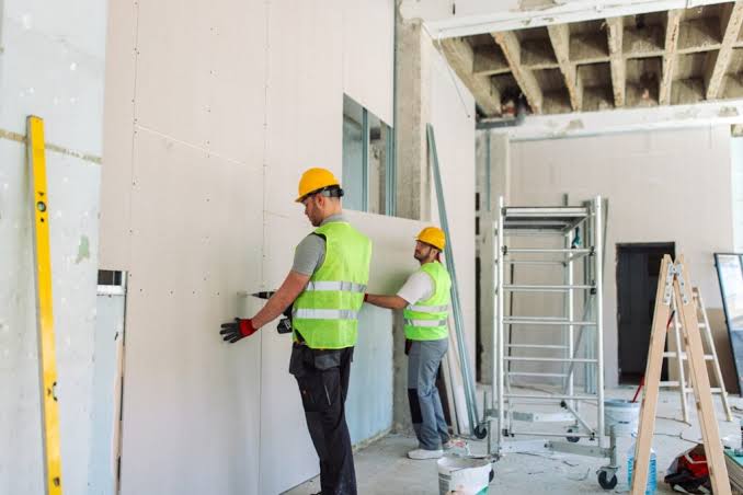 A specialist taping joints on-site to earn a professional dry lining qualification.