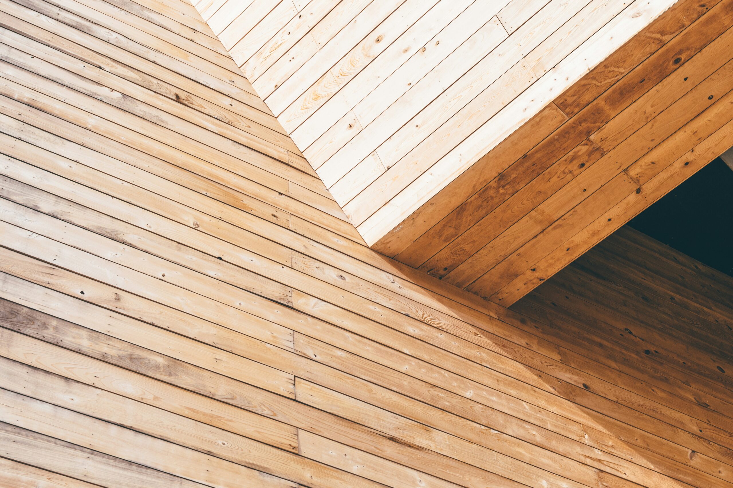 An experienced site carpenter installing timber roof trusses to satisfy his nvq wood occupations portfolio standards.