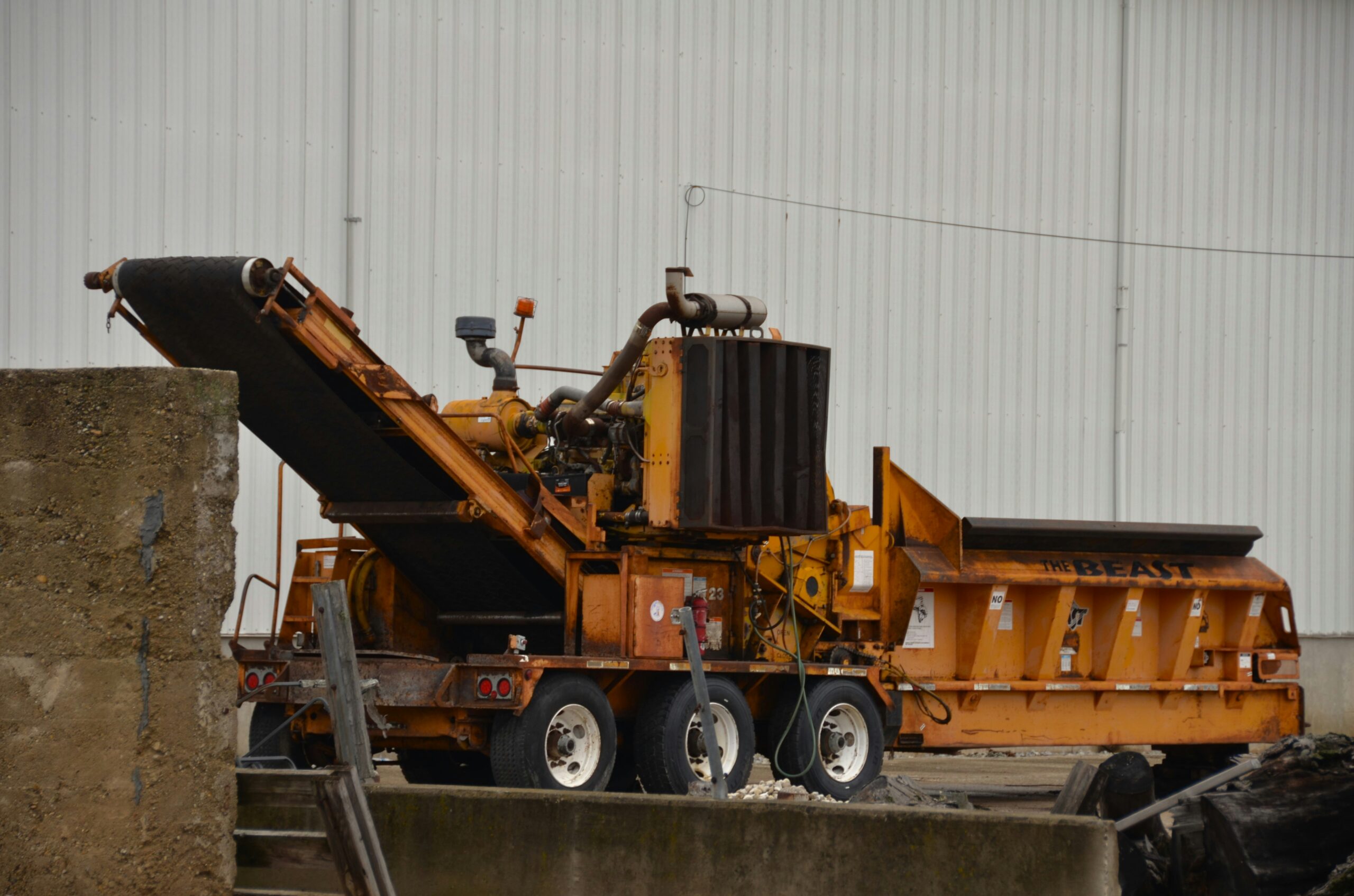 A trainee operating a forward tipping construction dumper vehicle during an official plant operator training course.