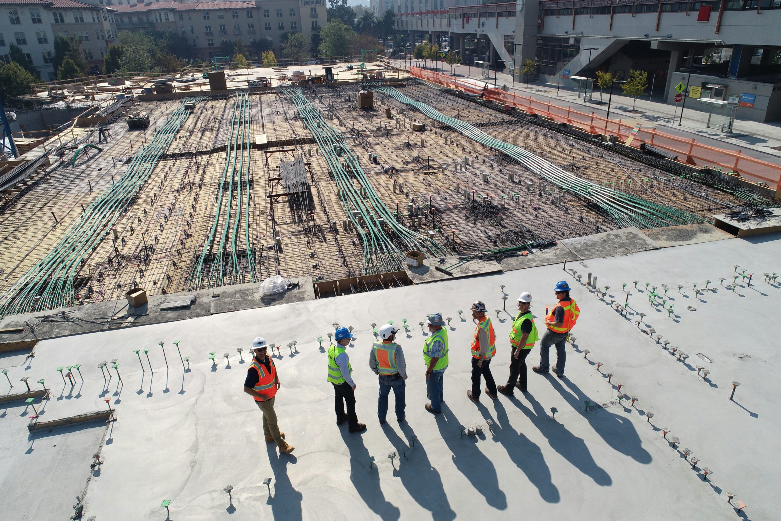 A construction site manager reviewing safety manuals during a CITB SMSTS Refresher Course workshop.