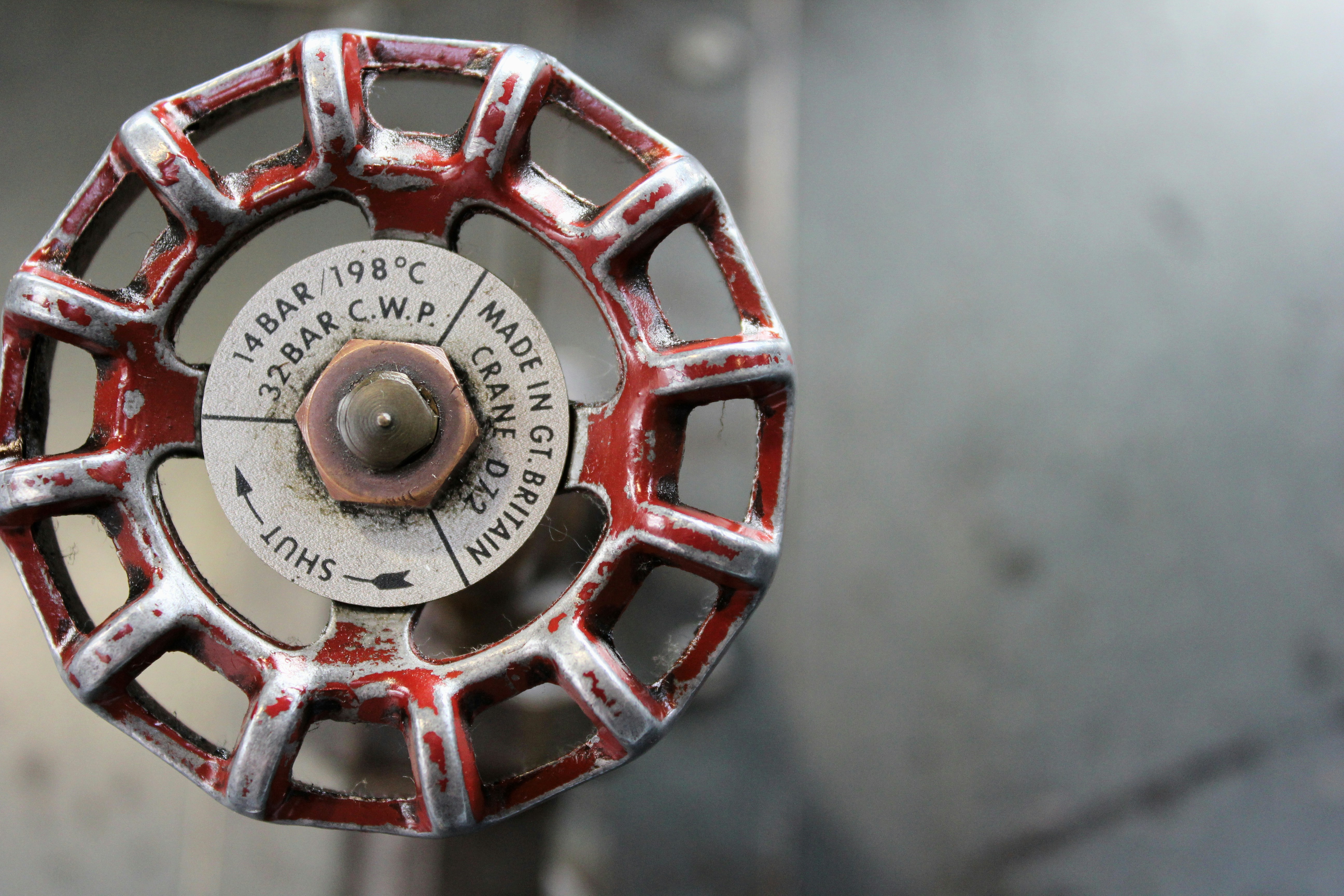 A certified technician carefully installing automatic fire sprinkler systems in the ceiling of a modern domestic home.