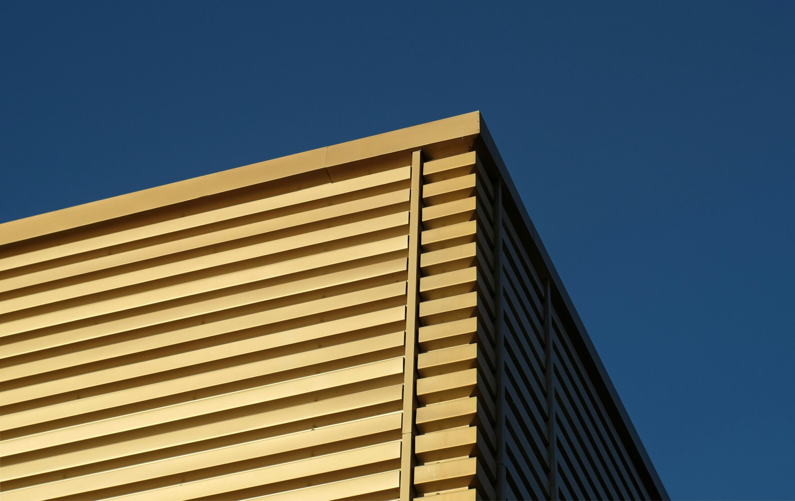 An experienced installer fixing external metal insulation sheets to complete his cladding occupations nvq portfolio.