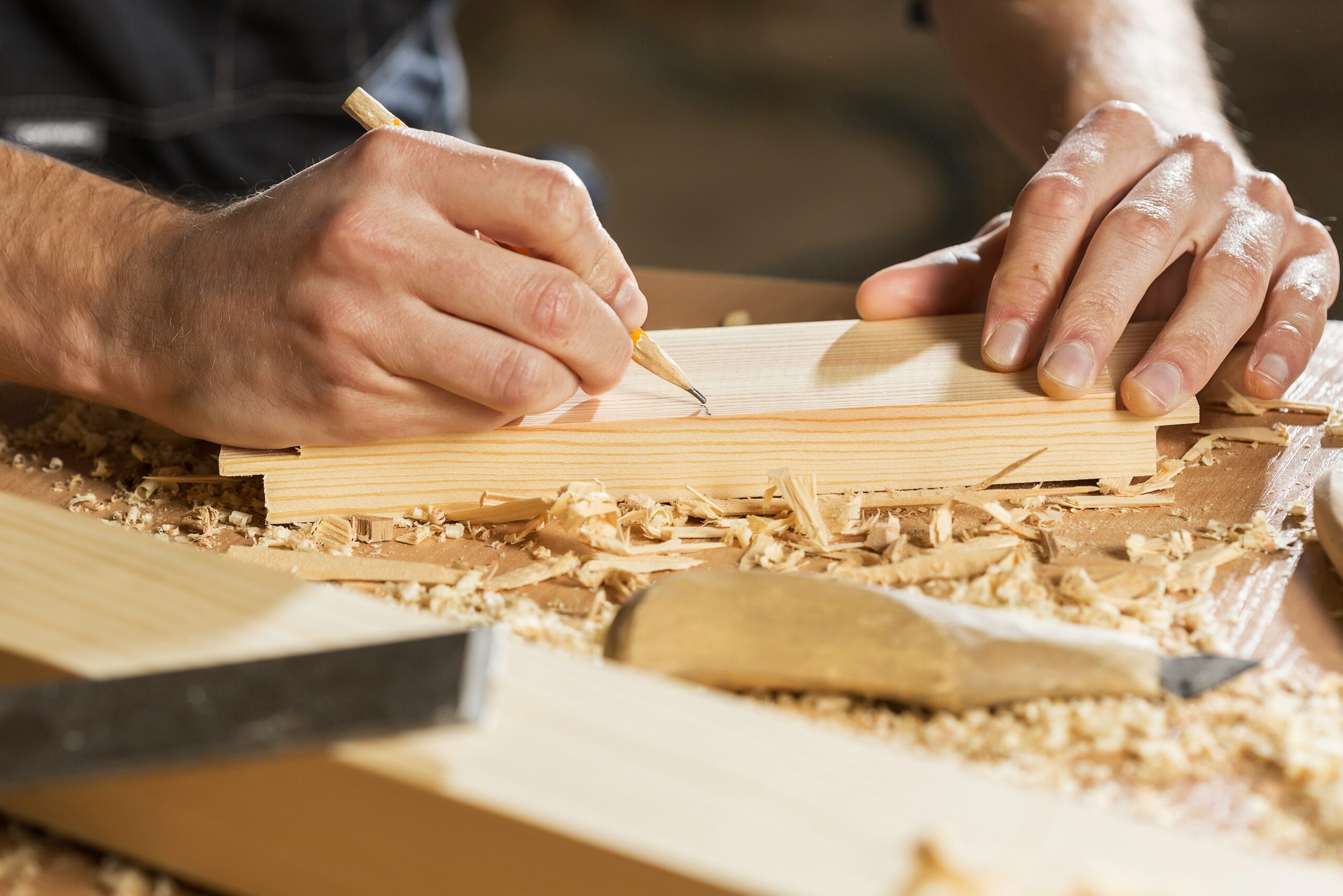 A professional UK joiner completing precise woodwork for his Level 3 Carpentry NVQ training portfolio.