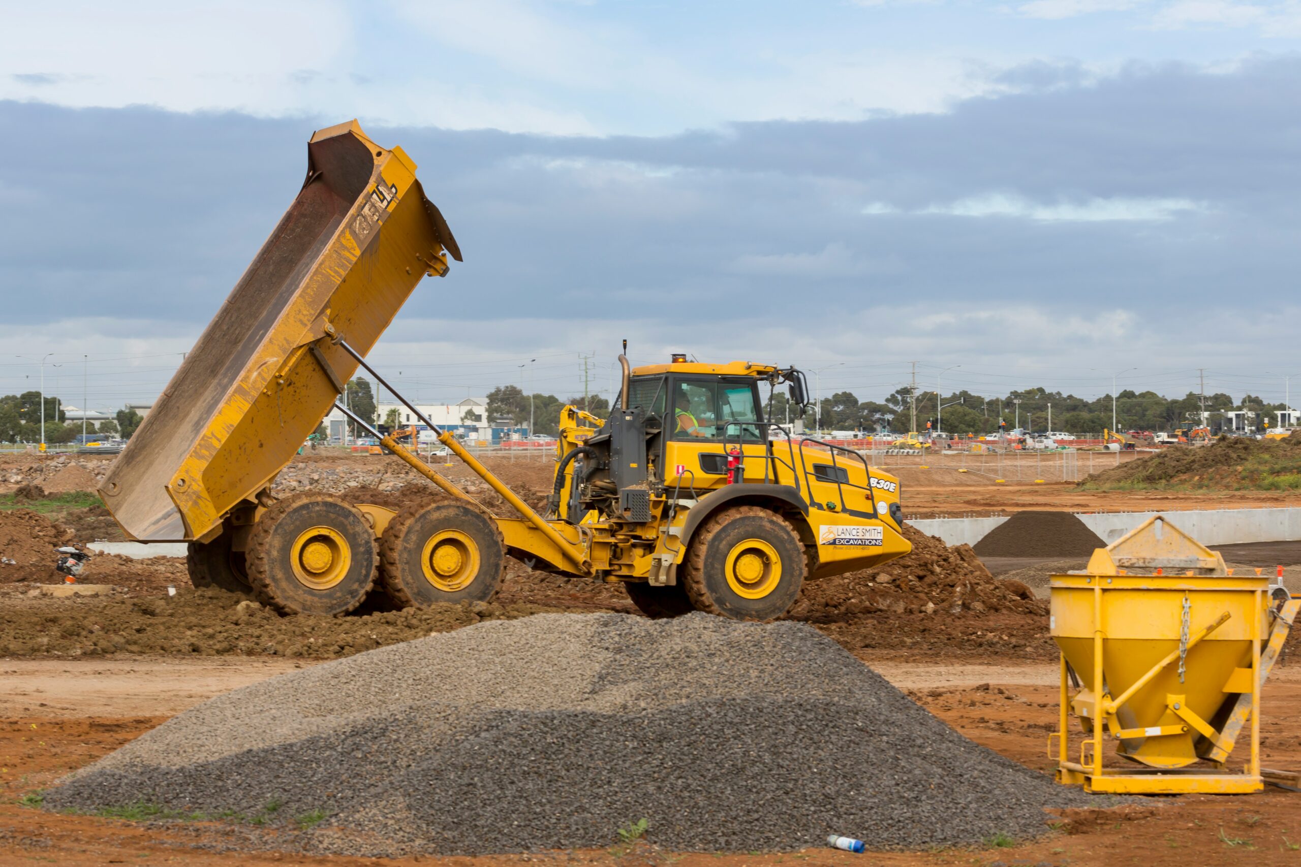 A professional site worker driving a machine while completing the CPCS NVQ Dumper qualification on a UK project.